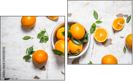 Orange style. Fresh oranges with leaves in a Cup . - Two-piece canvas print, Diptych