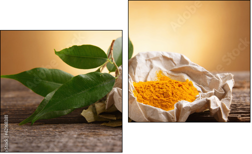 Tumeric powwder spice on wooden board with fresh leaves - Two-piece canvas print, Diptych