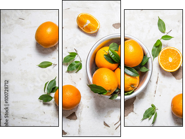 Orange style. Fresh oranges with leaves in a Cup . - Three-piece canvas print, Triptych