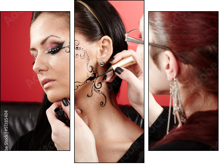 Brunette having applied face tattoo by makeup artist - Three-piece canvas print, Triptych