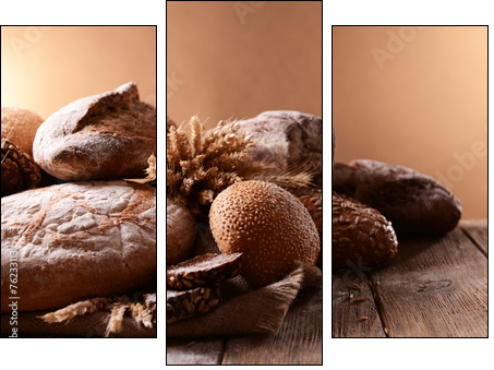 Different bread on table on brown background - Three-piece canvas print, Triptych
