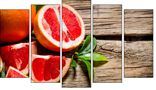 Fresh cut grapefruit with leaves. On wooden table. - Five-piece canvas print, Pentaptych