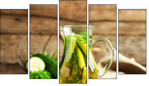 Glass ewer with fresh organic cucumber water on wooden table - Five-piece canvas print, Pentaptych